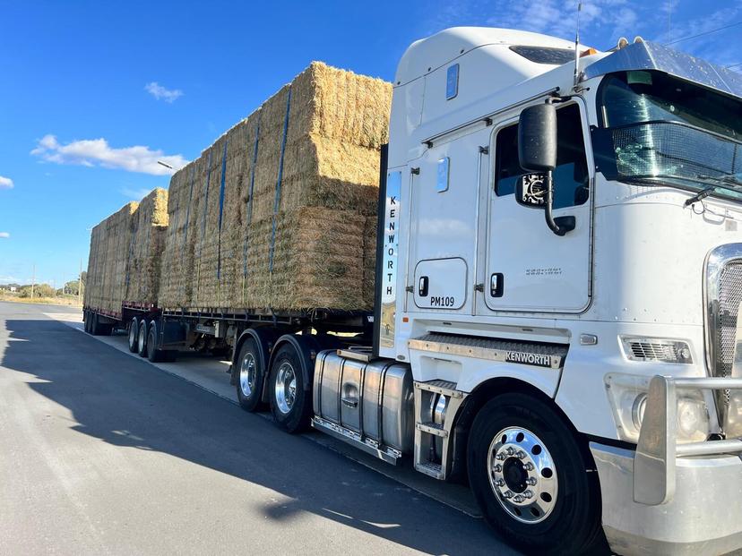 A Farm Direct truck loaded with big square bales